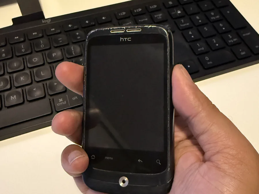 The original HTC Android phone bought in 2011 to build the first version of the app — photographed today at the founder's desk